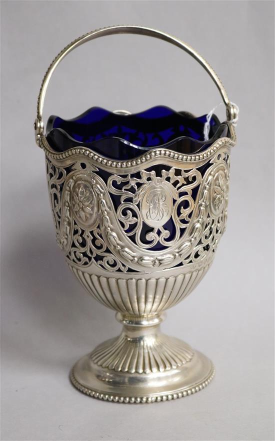 A Victorian pierced silver sugar vase with handle and blue glass liner, Robert Harper, London, 1876, height 14.2cm.